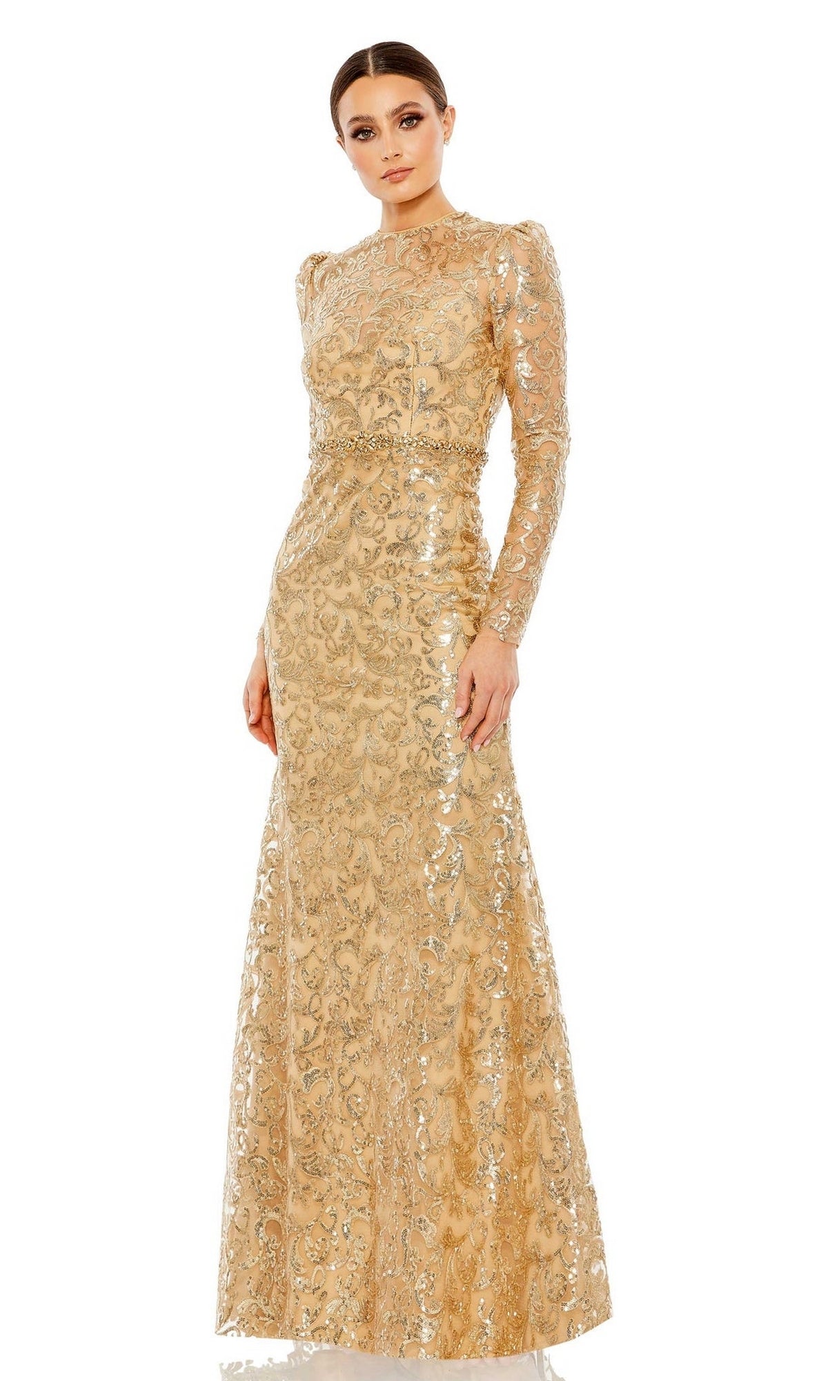 A woman in the Mac Duggal 68011 Long Beaded-Lace Formal Dress—gold, with long sleeves and a fitted waist—stands against a white background.
